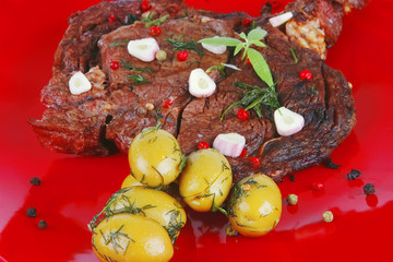 roast beef meat with olives on red