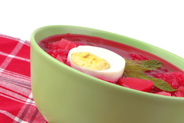 fresh beet vegetable soup in green bowl