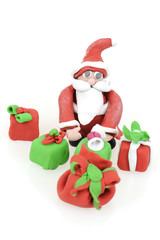 Santa Claus holding several Christmas gifts concept