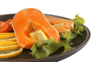 two salmon steak on dark dish