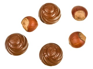 Chocolates and hazelnuts isolated on a white background