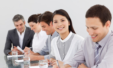 Smiling business partners taking notes in a meeting