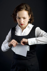 Serious woman bending sheet of paper