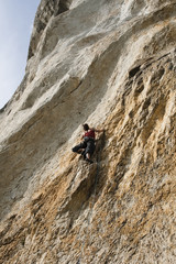 woman climbing on rocks
