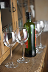 four glasses with green bottle