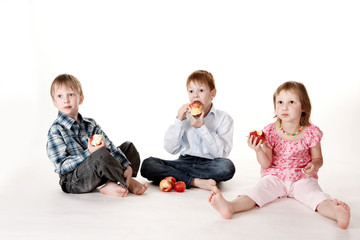 Three children with apples.