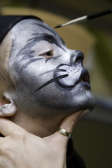 The boy makes a children's make-up