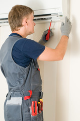 man repair air-conditioner