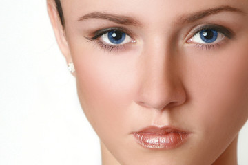 Fototapeta premium Half face of woman with blue eyes