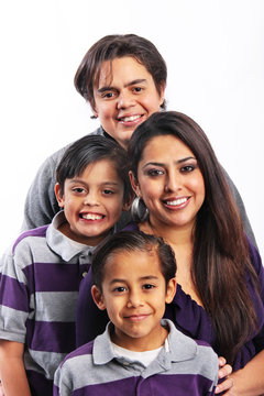 Happy family of four portrait in studio