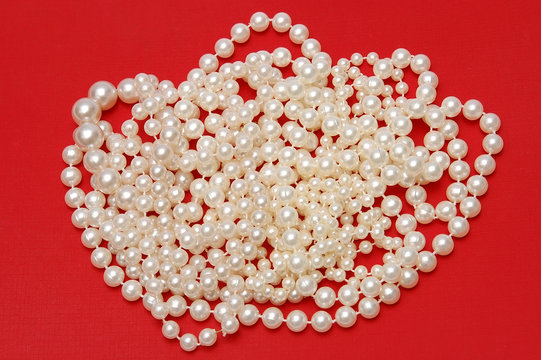 White beads on a red background