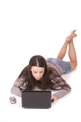 casual woman with a laptop, working on the floor.