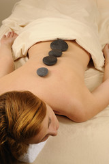 Obraz na płótnie Canvas Massage Hot Mineral Stones on Spine