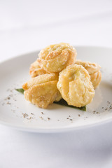 Five curry puffs on white plate.