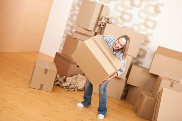 Fototapeta na wymiar Moving house: Woman holding big carton box