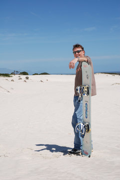 Man With Sandboard In The Dunes