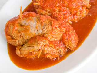 Meat roulade with tomato sauce on plate