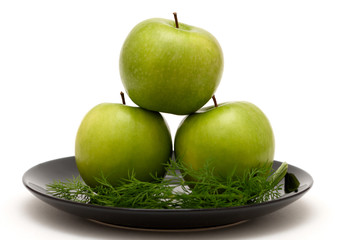 Three apples on a plate