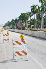 Street signs and barricades at a public construction site