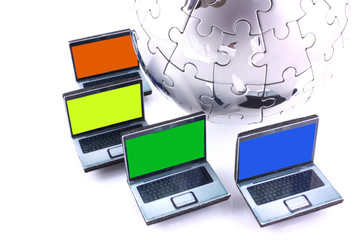 Laptops with one colour screens around a chrome jigsaw globe