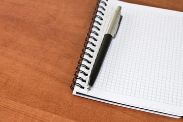 pen laying on a clear notebook