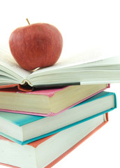 Stack of books with red apple