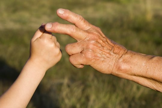 hand of garndmother and grandchild by game