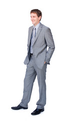 Young businessman standing with hands in pockets