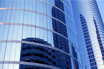 Obraz premium Blue mirror glass facade skyscraper buildings