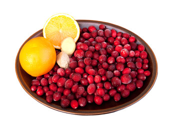 Dish of cranberries orange and root ginger