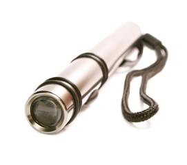 Metallic flashlight is isolated on the white isolated.