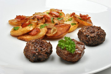 roasted potato with meat balls on a white plate