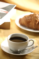 close up image of croissant and tea