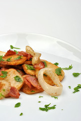 roasted potato with organic onion on a white plate