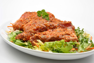 some marinated organic rib on healthy salad