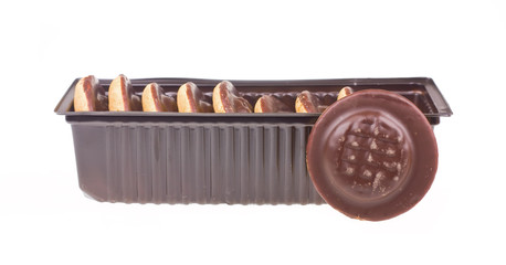 Some chocolate cookies in a box isolated on a white background.