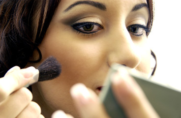 Woman applying makeup