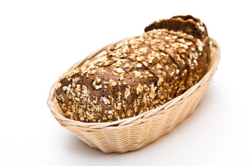 sliced wholemeal bread in wicker basket isolated