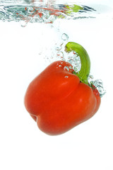 A paprika falling in water