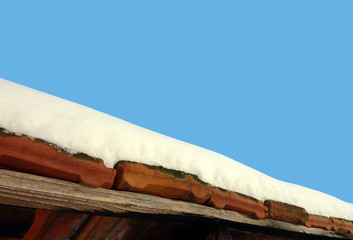 Sunshine on snowy old roof