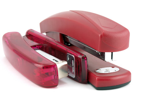 Two pink staplers