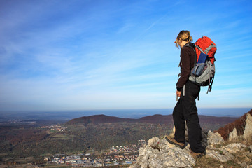 female Hiker is looking over the city
