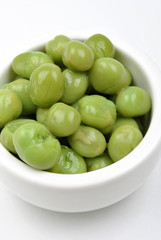 some organic and fresh pea in a white bowl