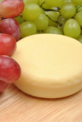 home made cheese with grapes in the background