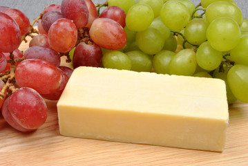 home made cheese with grapes in the background