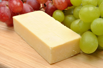 home made cheese with grapes in the background