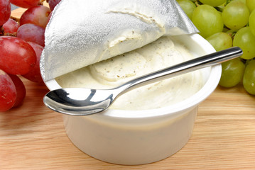 home made cheese with grapes in the background