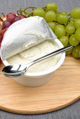 home made cheese with grapes in the background