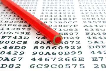 A red pencil on a sheet with encrypted data