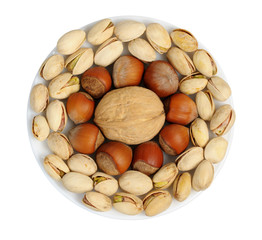Set of nuts on a white plate, isolation